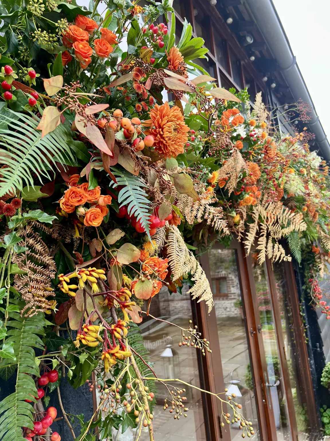 upwaltham barns wedding gallery autumn orange flowers door