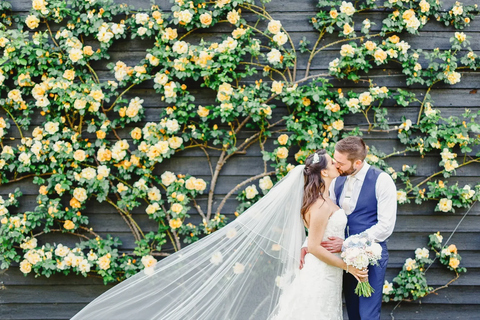 upwaltham barns wedding gardens snug couple flower wall