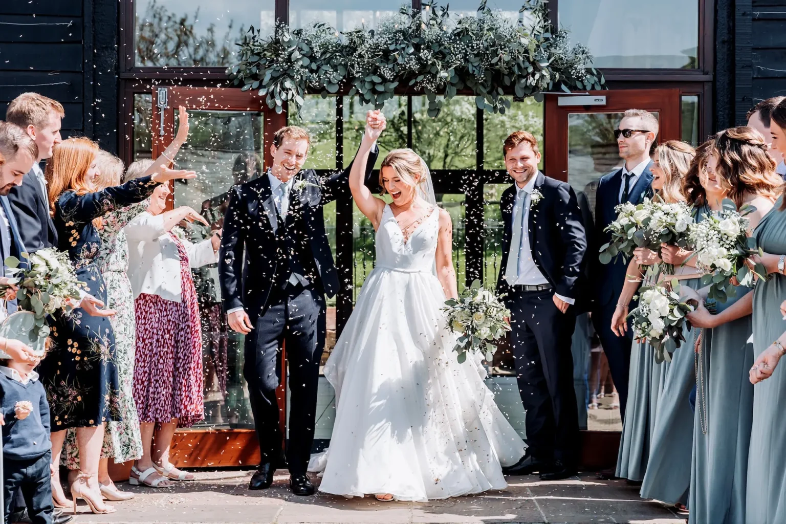 Upwaltham Barns bride and groom just married confetti shot