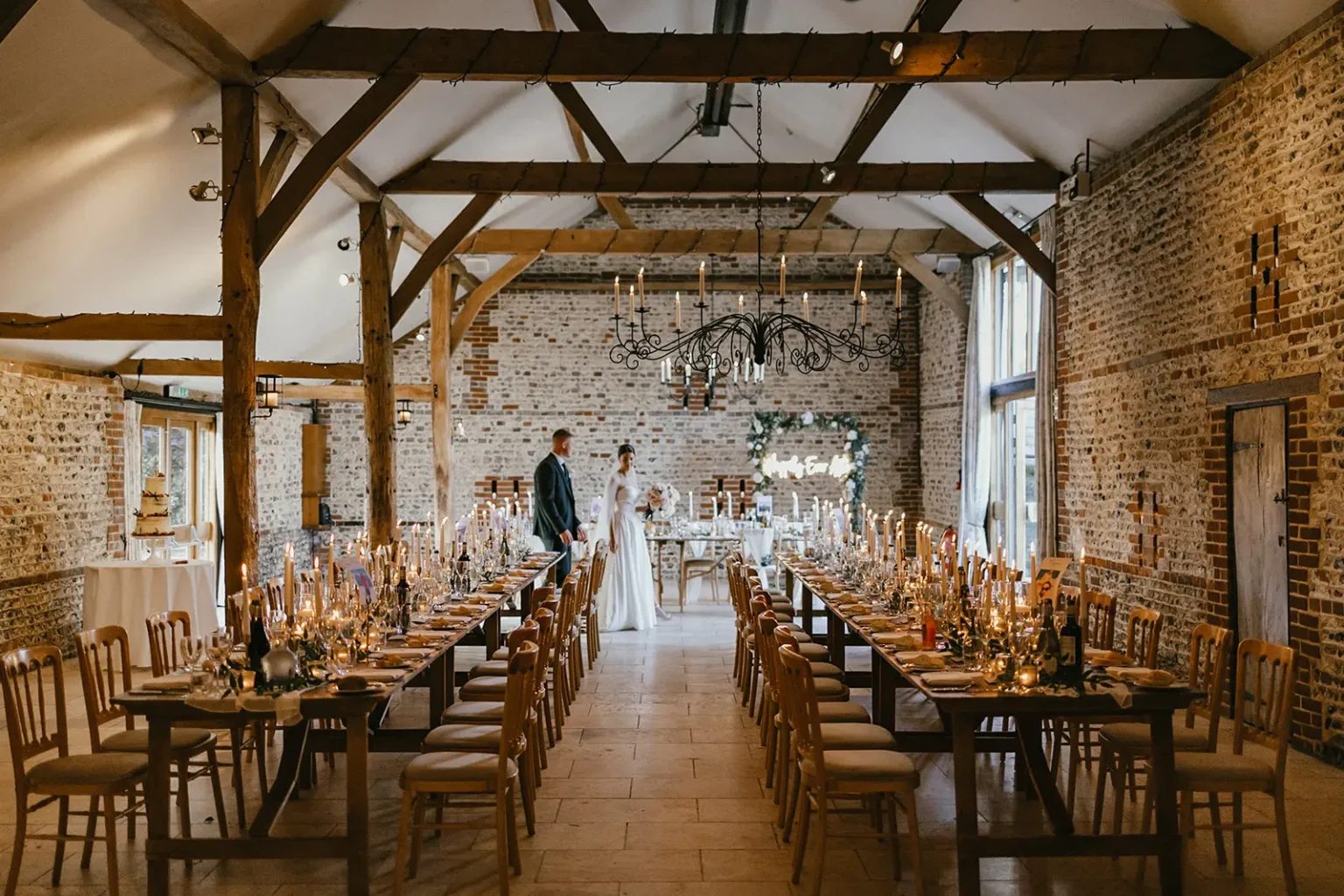 Upwaltham Barns wedding venue couple walking through South Barn