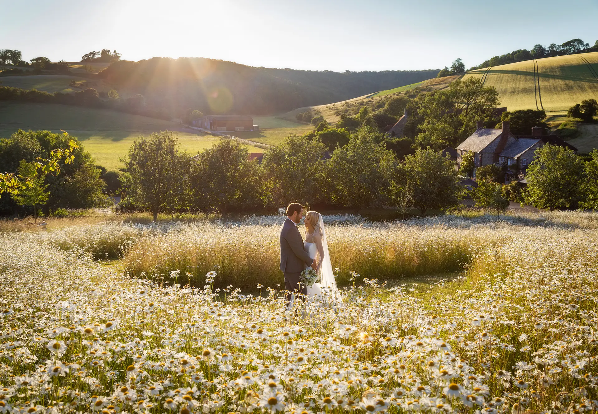 Upwaltham Barns couple in wild flower field