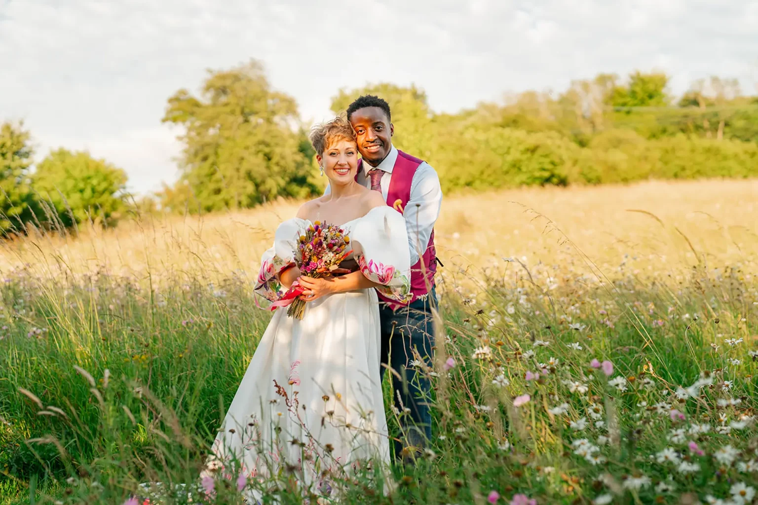 Upwaltham Barns couple in wildflower field
